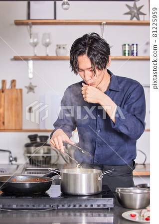 Young man in an apron to check the hardness of pasta Cooking boy image 81225959