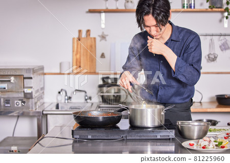 Young man in an apron to check the hardness of pasta Cooking boy image 81225960