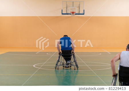 photo of wheelchairs and handicapped war veterans playing basketball on the court 81229413