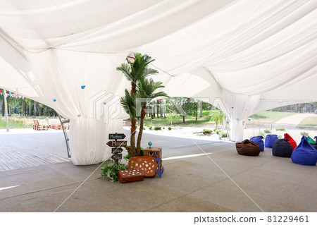 Soft beanbag chairs in an open-air tent 81229461