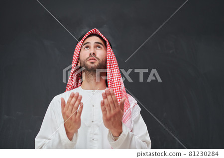 Arab man in traditional clothes praying to God or making dua Arab man in traditional clothes praying to God or making dua 81230284