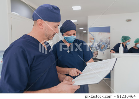 orthopedic doctor working together with his multiethnic team orthopedic doctor working together with his multiethnic team 81230464