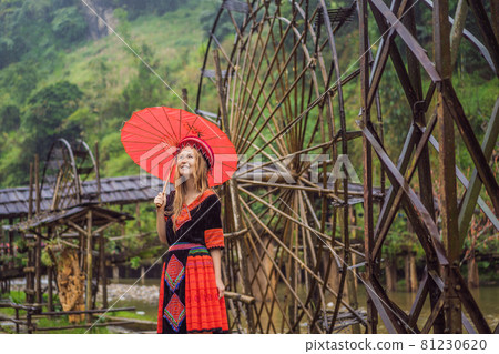 A female tourist dressed in the traditional dress of the inhabitants of the Vietnamese mountains, the Hmong. Woman in Sapa in the fog, Northwest Vietnam. Vietnam travel concept. UNESCO heritage 81230620