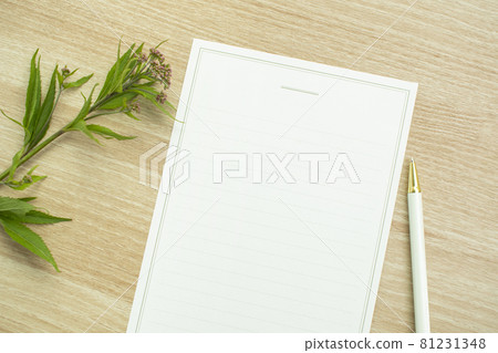 White paper mockup with flowers on wooden table White paper mockup with flowers on wooden table 81231348