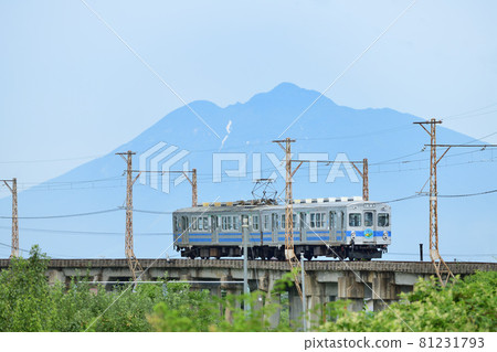 Konan Railway Oogi Line 7000 series train that goes through the concrete bridge between Mt. Iwaki and the apple field Konan Railway Oogi Line 7000 series train that goes through the concrete bridge between Mt. Iwaki and the apple field 81231793