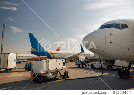 View of white airplane during refueling at airport outdoors on a daytime. Aircraft details 81233404