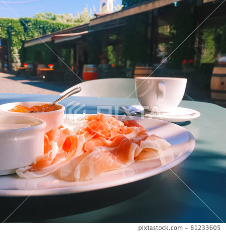 Breakfast outdoors in summer, ham, jam, butter and ham Breakfast outdoors in summer, ham, jam, butter and ham 81233605