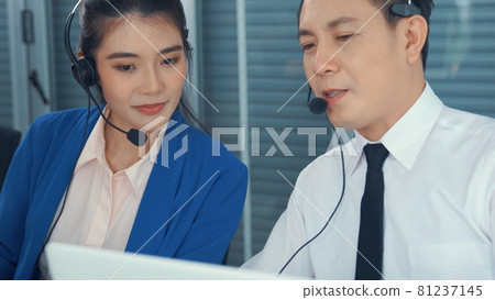 Business people wearing headset working actively in office 81237145