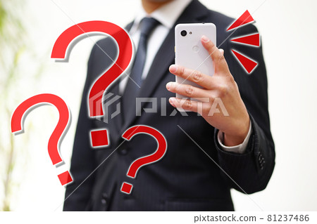 Businessman looking at a smartphone Businessman looking at a smartphone 81237486