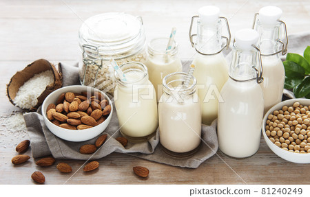 Alternative types of vegan milks in glass bottles 81240249