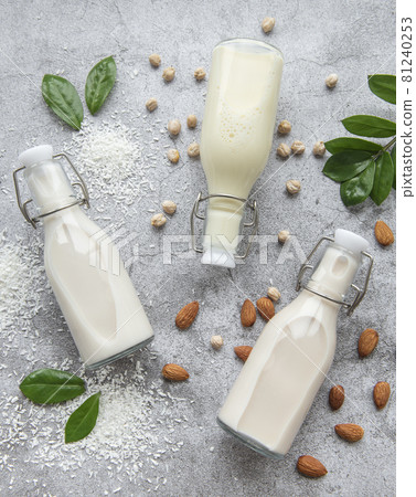 Alternative types of vegan milks in glass bottles Alternative types of vegan milks in glass bottles 81240253