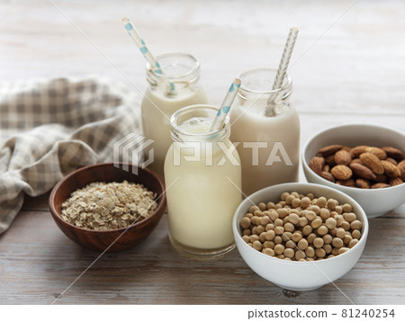 Bottles with different vegetable milk 81240254