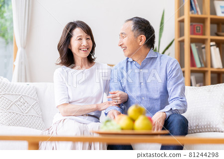 Senior couple relaxing in the living room Senior couple relaxing in the living room 81244298
