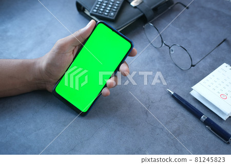 rear view of young man using smart phone on table rear view of young man using smart phone on table 81245823