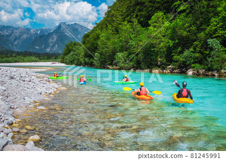 Kayakers exercising and rowing on the Soca river, Bovec, Slovenia 81245991
