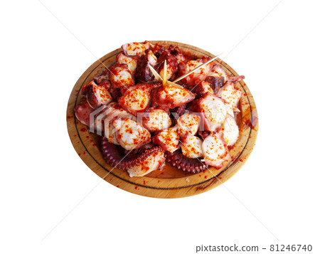 Pulpo a la gallega in Spanish meaning Galician-style octopus served on the wooden plate isolated on white. 81246740