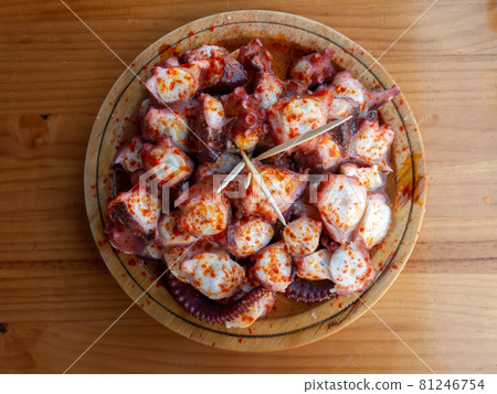 Galician-style octopus a traditional Galician dish served on the wooden plate top view. 81246754
