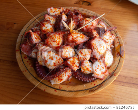 Pulpo a la gallega in Spanish meaning Galician-style octopus served on the wooden plate. 81246755