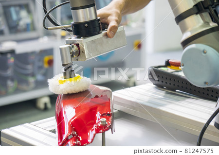 The engineer checking robotic arm polishing the automotive painting parts. The engineer checking robotic arm polishing the automotive painting parts. 81247575