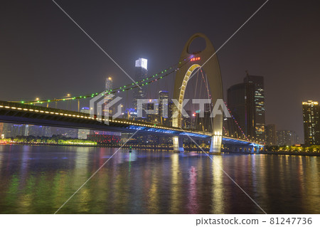 Guangzhou cityscape skyline over the Pearl River with Liede Bridge illuminated at night in Guangzhou, China. 81247736