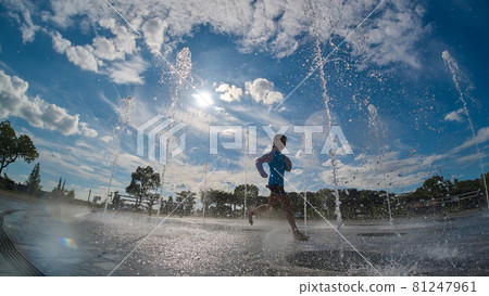 A child playing happily at the water playground in the summer park 81247961