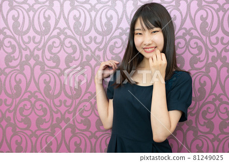 Purple gothic wallpaper and smiling woman in her twenties 81249025