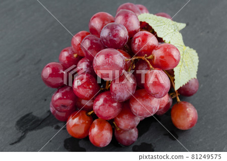 Ripe red grape on the dark background 81249575