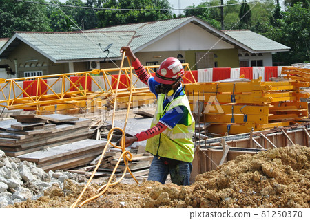 JOHOR, MALAYSIA -MARCH 29, 2016: Construction workers spraying the anti termite chemical treatment to the soil at the construction site. JOHOR, MALAYSIA -MARCH 29, 2016: Construction workers spraying the anti termite chemical treatment to the soil at the construction site. 81250370
