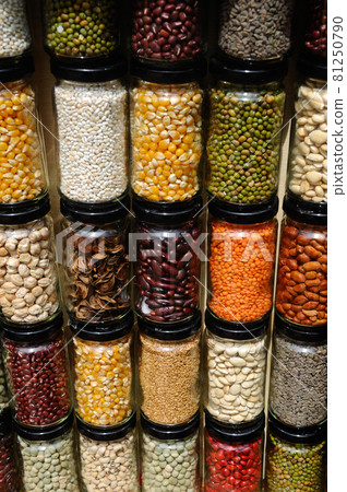 PUTRAJAYA, MALAYSIA -MAY 30, 2016: Seeds, nuts and grains in bottles and stacked against a wall. 81250790