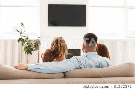 Young parents with children relaxing together in living room at home Young parents with children relaxing together in living room at home 81252571