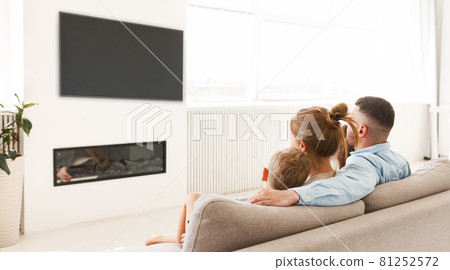 Young parents with children relaxing together in living room at home Young parents with children relaxing together in living room at home 81252572