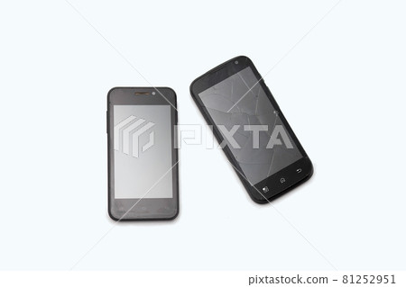 Two black phones lie on a white background. The broken smartphone. Cracks on the screen Two black phones lie on a white background. The broken smartphone. Cracks on the screen 81252951