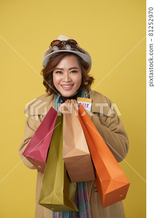 Exited Woman Holding Paper Bags 81252970