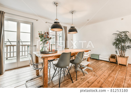 Bright dining room with decorative table and chairs Bright dining room with decorative table and chairs 81253180