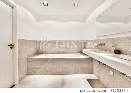 Beautiful bathroom with a big bathtub and white big windows 81253254