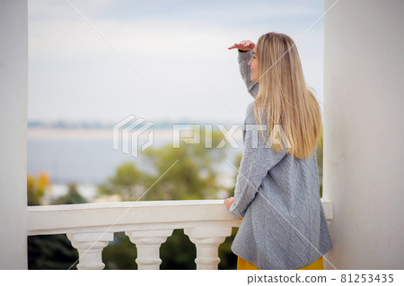 young woman lies and rests on an unusual bench in the park. Beautiful modern bench 81253435
