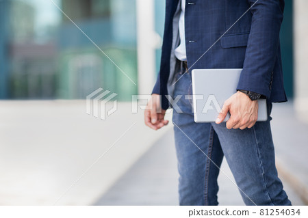 Cropped of man in formal outfit holding digital tablet Cropped of man in formal outfit holding digital tablet 81254034