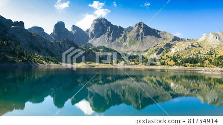 Allos lake in the morning during summer time, with mirror effect, mountains reflecting on the lake Allos lake in the morning during summer time, with mirror effect, mountains reflecting on the lake 81254914