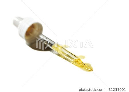 Liquid oil serum drop in pipette isolated on white background. Retinol, aha, bha acid, collagen skincare fluid, photo with shallow depth of field. Gold essence in dropper for beauty treatment 81255001