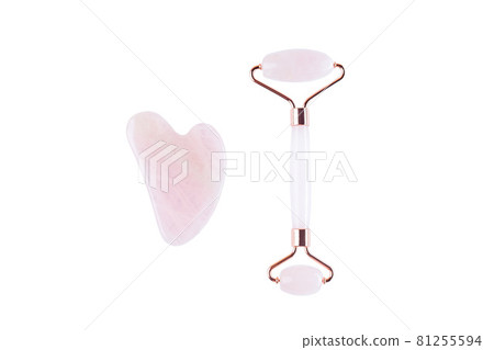 Rose quartz crystal facial roller and massage tool Gua sha isolated on white background Rose quartz crystal facial roller and massage tool Gua sha isolated on white background 81255594