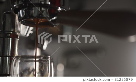Low angle shot of pulling espresso with naked portafilter 81255879