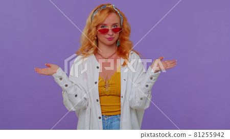 Seductive cheerful stylish girl in white shirt wearing sunglasses, charming smile on purple wall Seductive cheerful stylish girl in white shirt wearing sunglasses, charming smile on purple wall 81255942