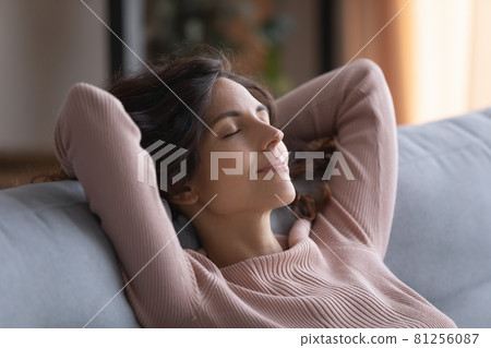 Smiling woman close her eyes breath fresh air relaxing indoor 81256087