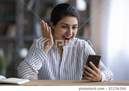 Excited Indian woman shocked by good online deal 81256166