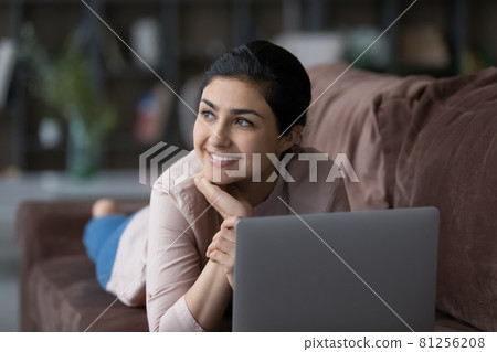 Happy Indian woman distracted form computer work planning Happy Indian woman distracted form computer work planning 81256208
