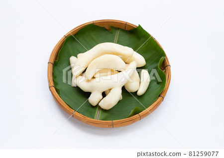 Young ginger peeled in bamboo basket on white background. 81259077