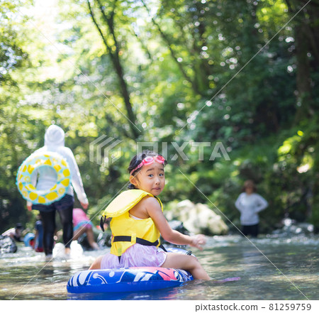 Children enjoying playing in the river Children enjoying playing in the river 81259759