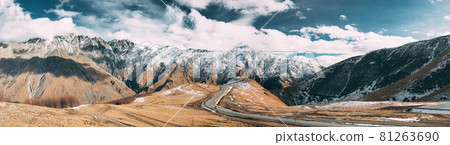 Stepantsminda, Gergeti, Georgia. Famous Gergeti Trinity Tsminda Sameba Church In Early Winter Panoramic Landscape. Panorama Of Beautiful Georgian Mountains Landscape Stepantsminda, Gergeti, Georgia. Famous Gergeti Trinity Tsminda Sameba Church In Early Winter Panoramic Landscape. Panorama Of Beautiful Georgian Mountains Landscape 81263690