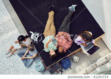 Group of Kids Relaxing in School Lounge Group of Kids Relaxing in School Lounge 81263724