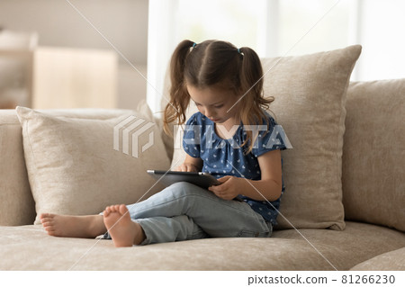 Focused gen Z preschooler kid using tablet at home Focused gen Z preschooler kid using tablet at home 81266230